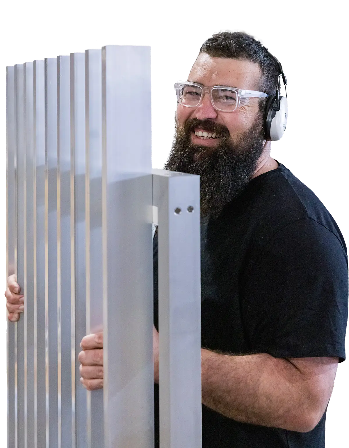 Jonny in the workshop, holding a freshly machined TrueBatten panel
