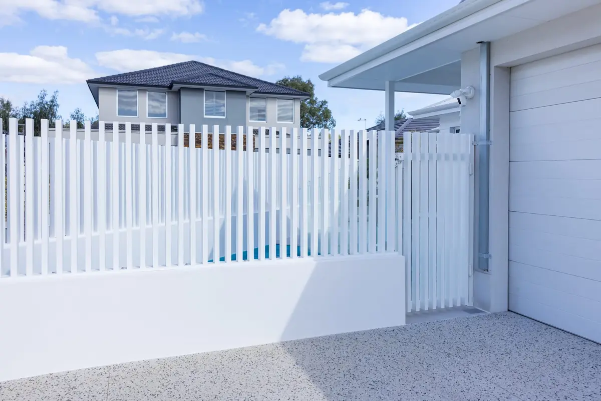 A completed aluminium batten pool fence and gate